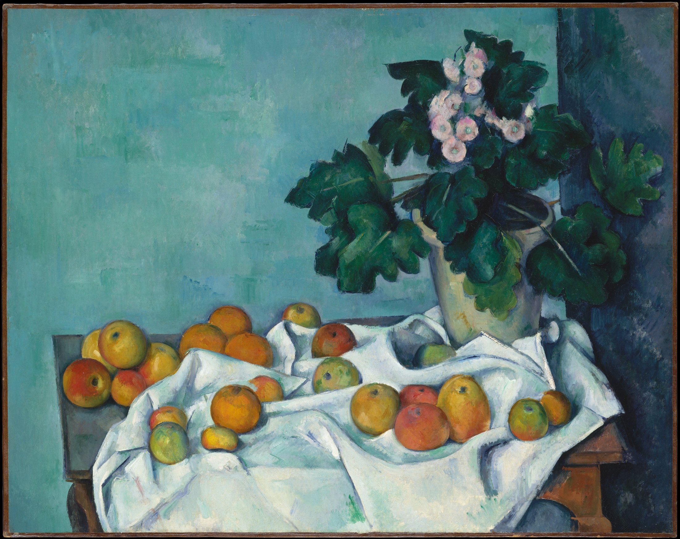 A still life of apples on a white cloth beside a pot of primroses